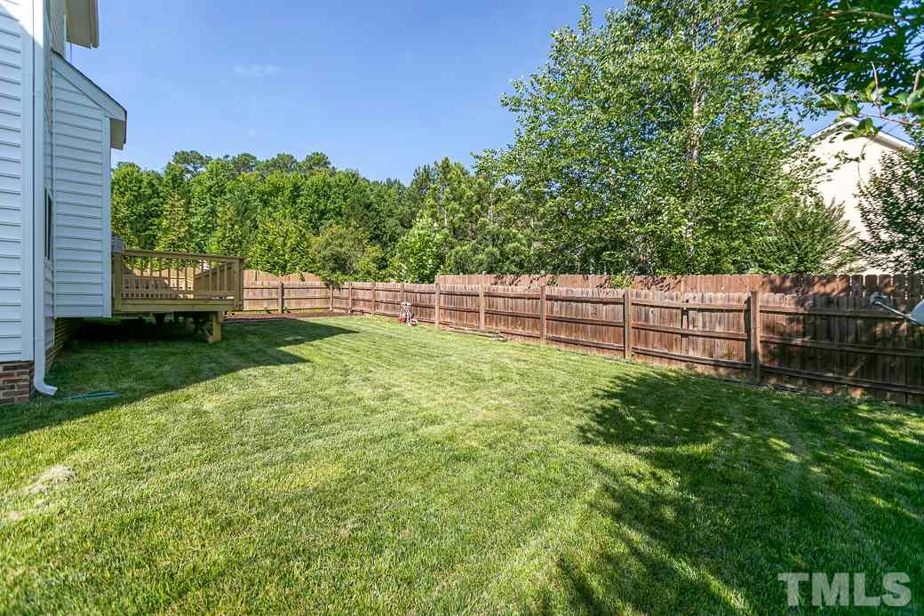 108 Quarryrock Road Holly Springs, NC 27540 - Photo 27 of 30 a view of a backyard with a garden