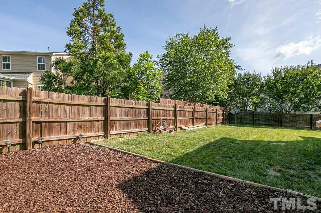 108 Quarryrock Road Holly Springs, NC 27540 - Photo 28 of 30 a view of a backyard with a garden