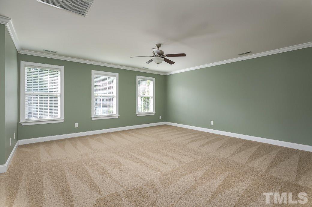 108 Quarryrock Road Holly Springs, NC 27540 - Photo 7 of 30 a view of an empty room with windows