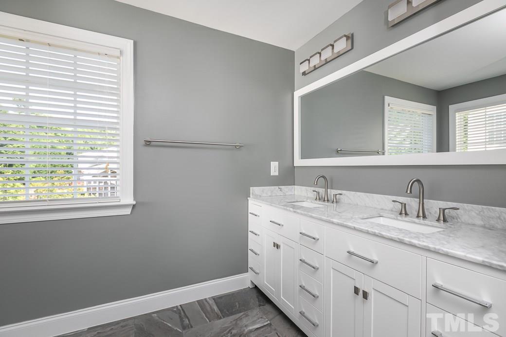 108 Quarryrock Road Holly Springs, NC 27540 - Photo 10 of 30 a bathroom with a granite countertop sink and a mirror
