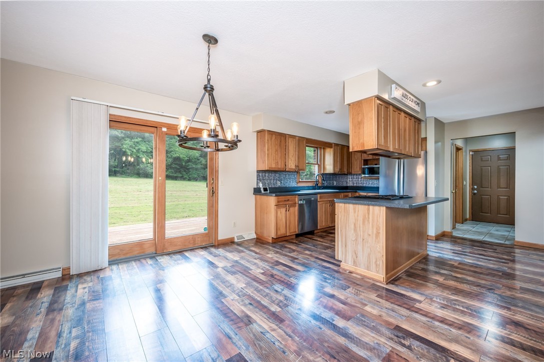 1666 Warner Road Vienna, OH 44473 - Photo 5 of 41 Kitchen featuring a wealth of natural light, appliances with stainless steel finishes, dark hardwood / wood-style floors, and decorative light fixtures