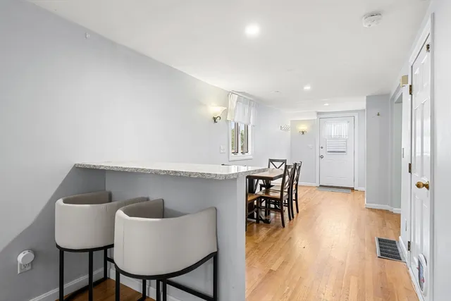 a kitchen with furniture and wooden floor