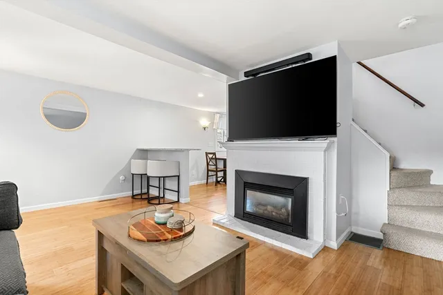 a living room with furniture a fireplace and a flat screen tv