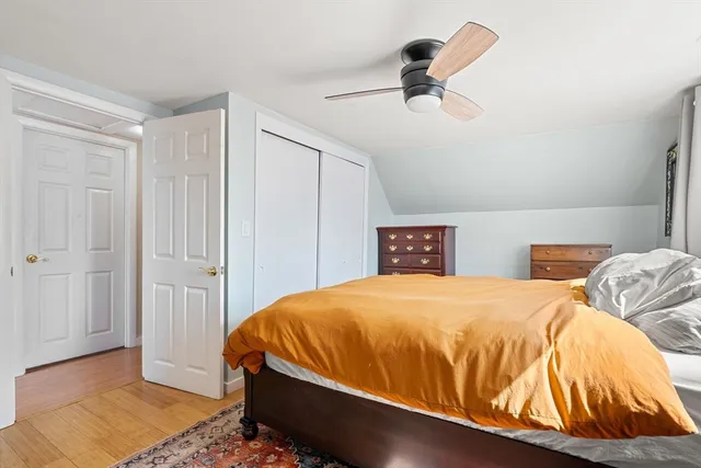 a bedroom with a bed and a ceiling fan