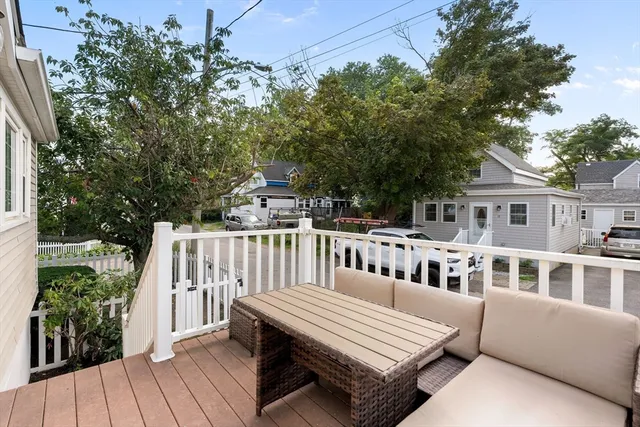 a view of balcony with wooden floor and seating space