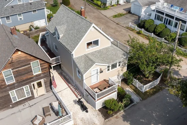 an aerial view of a house with a yard