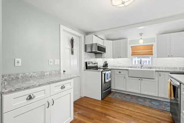 a kitchen with granite countertop cabinets stainless steel appliances a sink and a counter top space