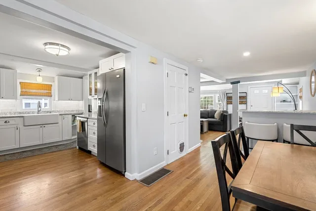 a kitchen with cabinets and wooden floor