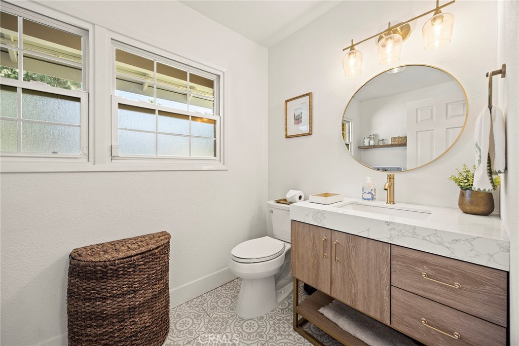 15914 West Road Whittier, CA 90603 - Photo 30 of 47 a bathroom with a toilet a sink and a mirror