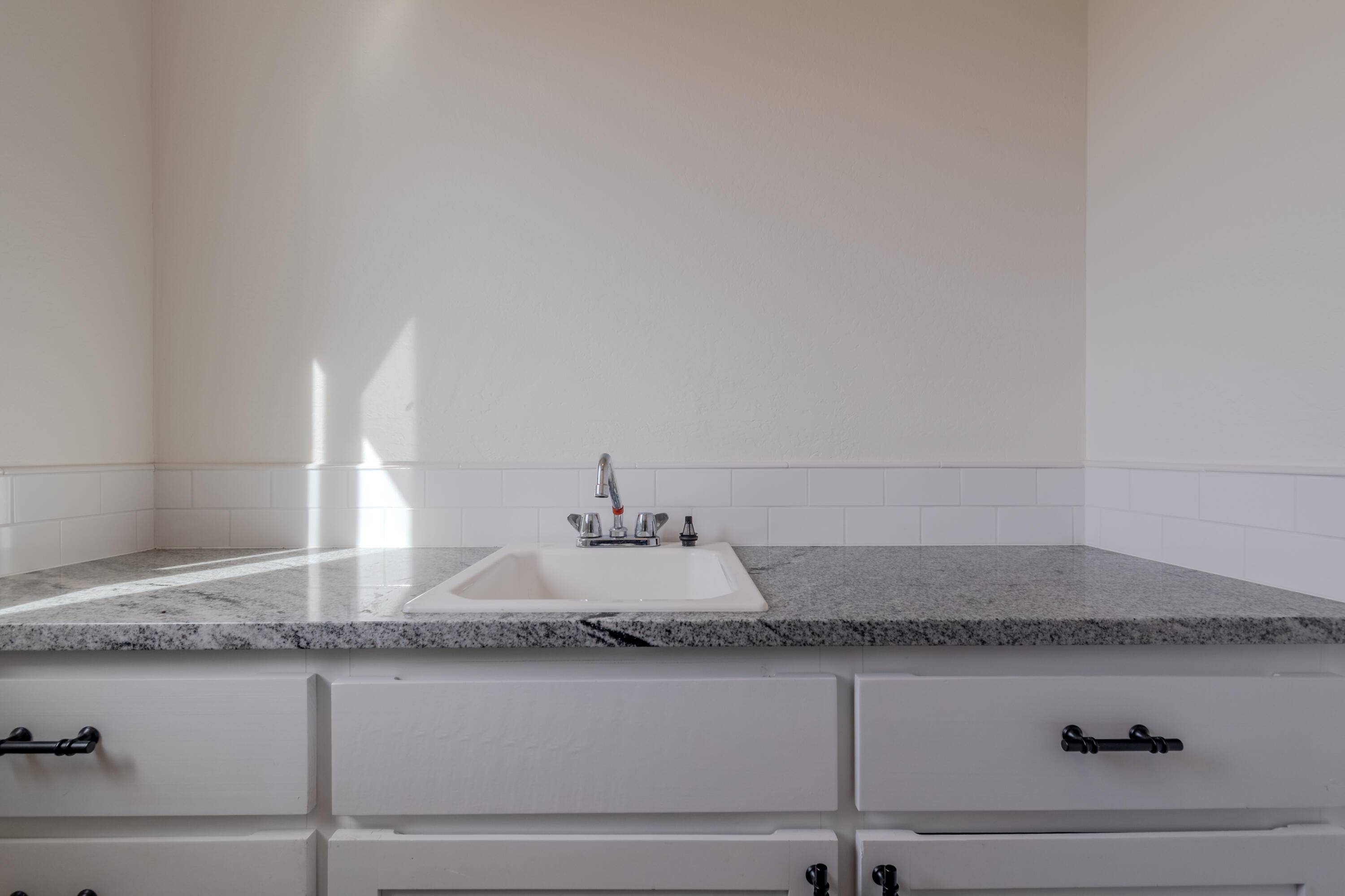 21 Cerulean Terrace Eagle Point, OR 97524 - Photo 12 of 30 a bathroom with a granite countertop sink and white cabinets