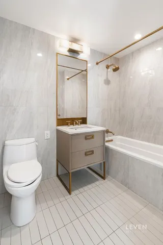 a bedroom with a large bed and a potted plant