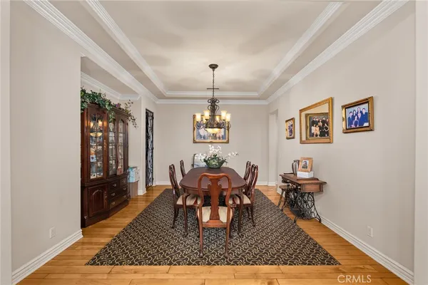 a large hall with stainless steel appliances granite countertop a refrigerator and a large window