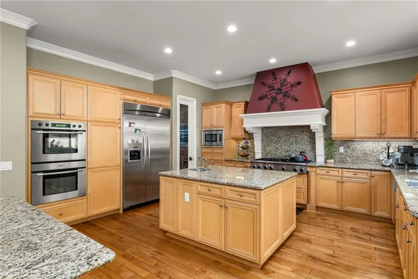 a bathroom with a sink a mirror and a potted plant