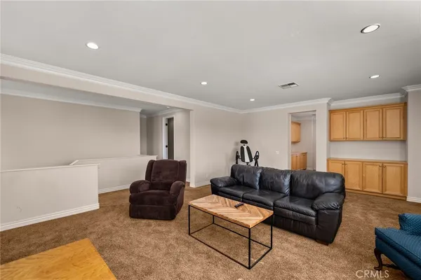 a bedroom with furniture and a book shelf