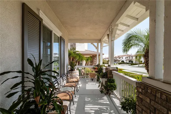 a view of an entryway with wooden floor and livingroom view