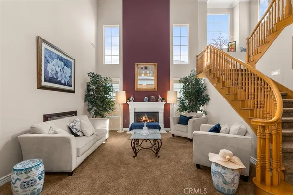 a dining room with wooden floor a chandelier a wooden table and chairs