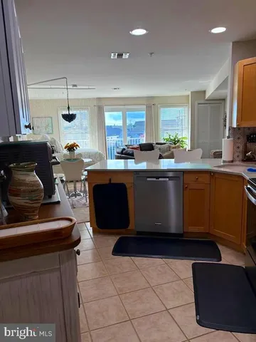 a kitchen with a sink a stove and chairs