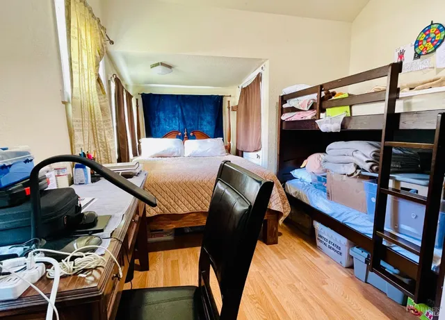 a bedroom with a bed and a window