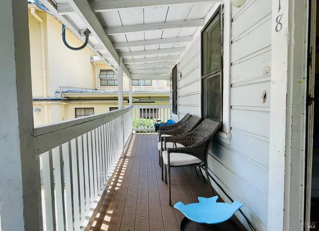 a view of a living room with furniture and a floor to ceiling window