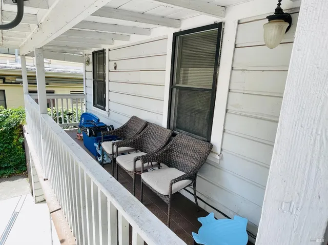 a view of balcony with furniture