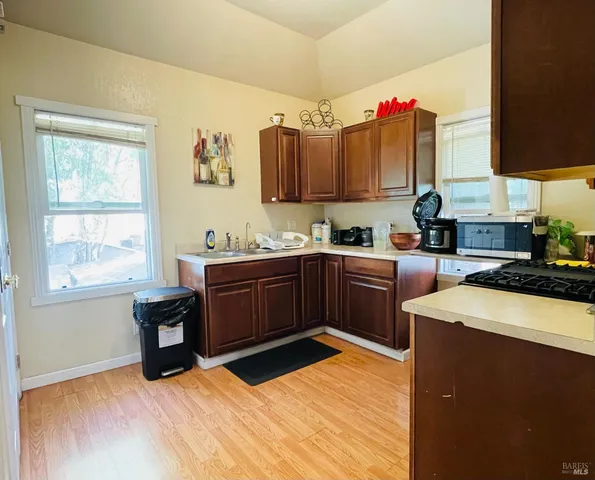 a kitchen with a sink cabinets and window