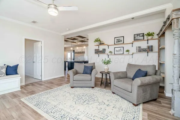 a living room with furniture and wooden floor