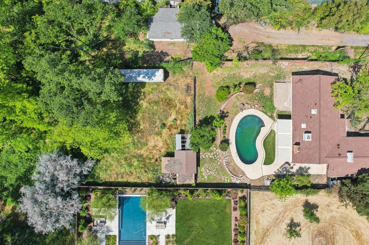an aerial view of a house with swimming pool and outdoor space