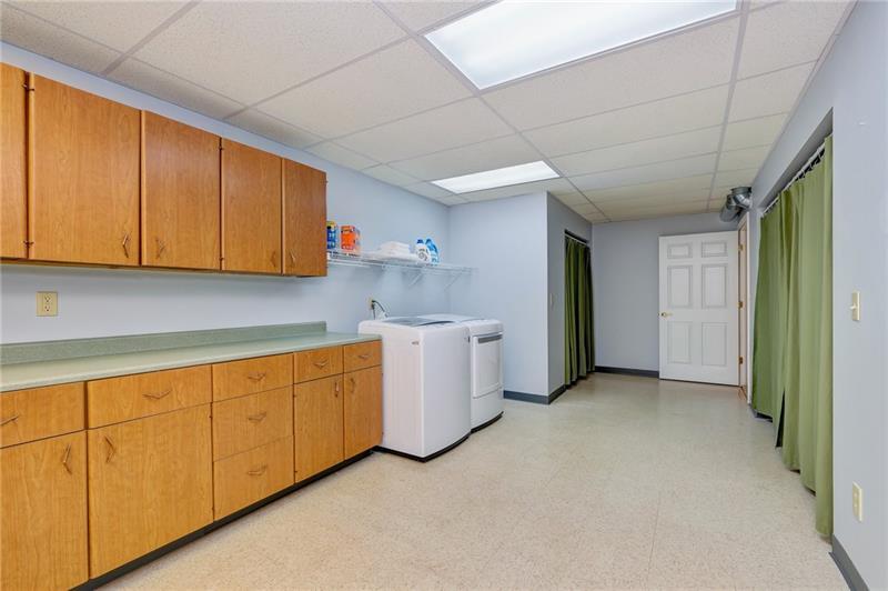 130 West Cruikshank Road Butler, PA 16002 - Photo 23 of 25 Now here is a laundry room! Plenty of cabinetry space for storage, and counter space for folding clothes. Peek behind the curtains to find lots of storage space.