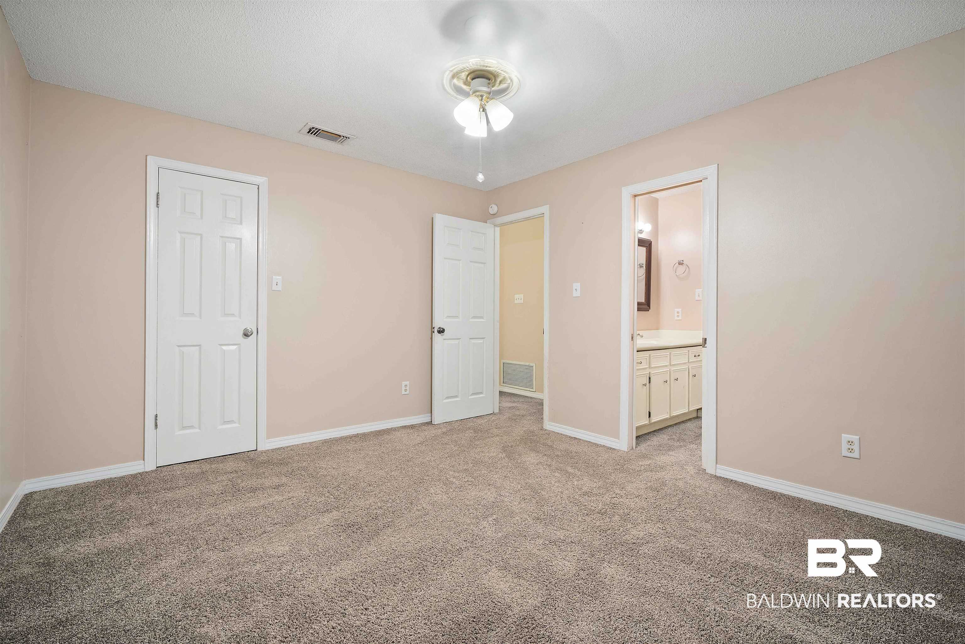804 Wildwood Avenue Mobile, AL 36609 - Photo 25 of 30 Unfurnished bedroom featuring a closet, light colored carpet, and ensuite bathroom