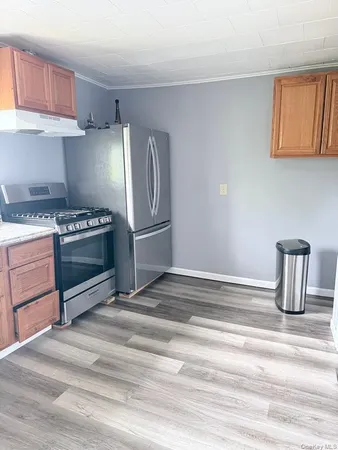 a kitchen with granite countertop a stove and a cabinets