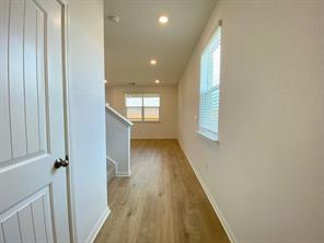 213 Saide Street Georgetown, TX 78626 - Photo 5 of 32 Long hallway featuring wood-finish flooring, recessed lighting, and a window with blinds
