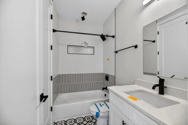 a bathroom with a bathtub and a sink