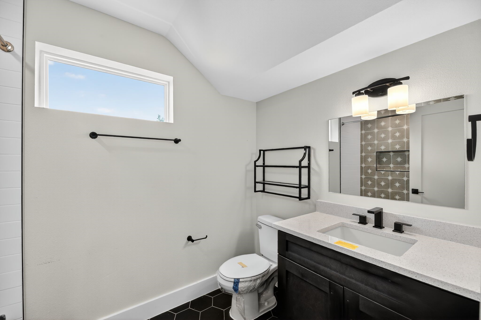 6107 Palm Circle Austin, TX 78741 - Photo 27 of 30 a bathroom with a sink toilet and mirror