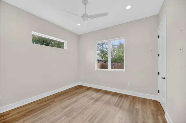 wooden floor in an empty room with a window