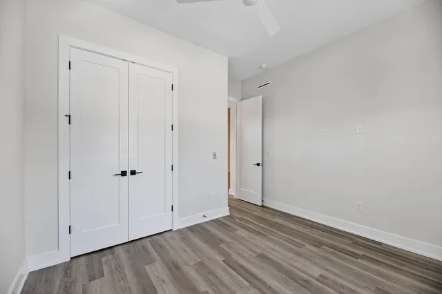 a view of an empty room with closet area