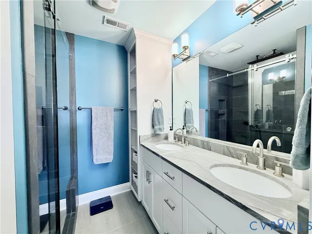 a bathroom with a double vanity sink and mirror