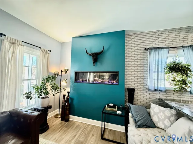 a living room with furniture and wooden floor