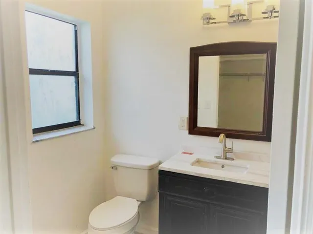 a view of a hallway with wooden floor and entryway