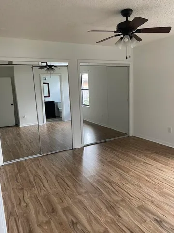 a kitchen with a sink refrigerator and cabinets