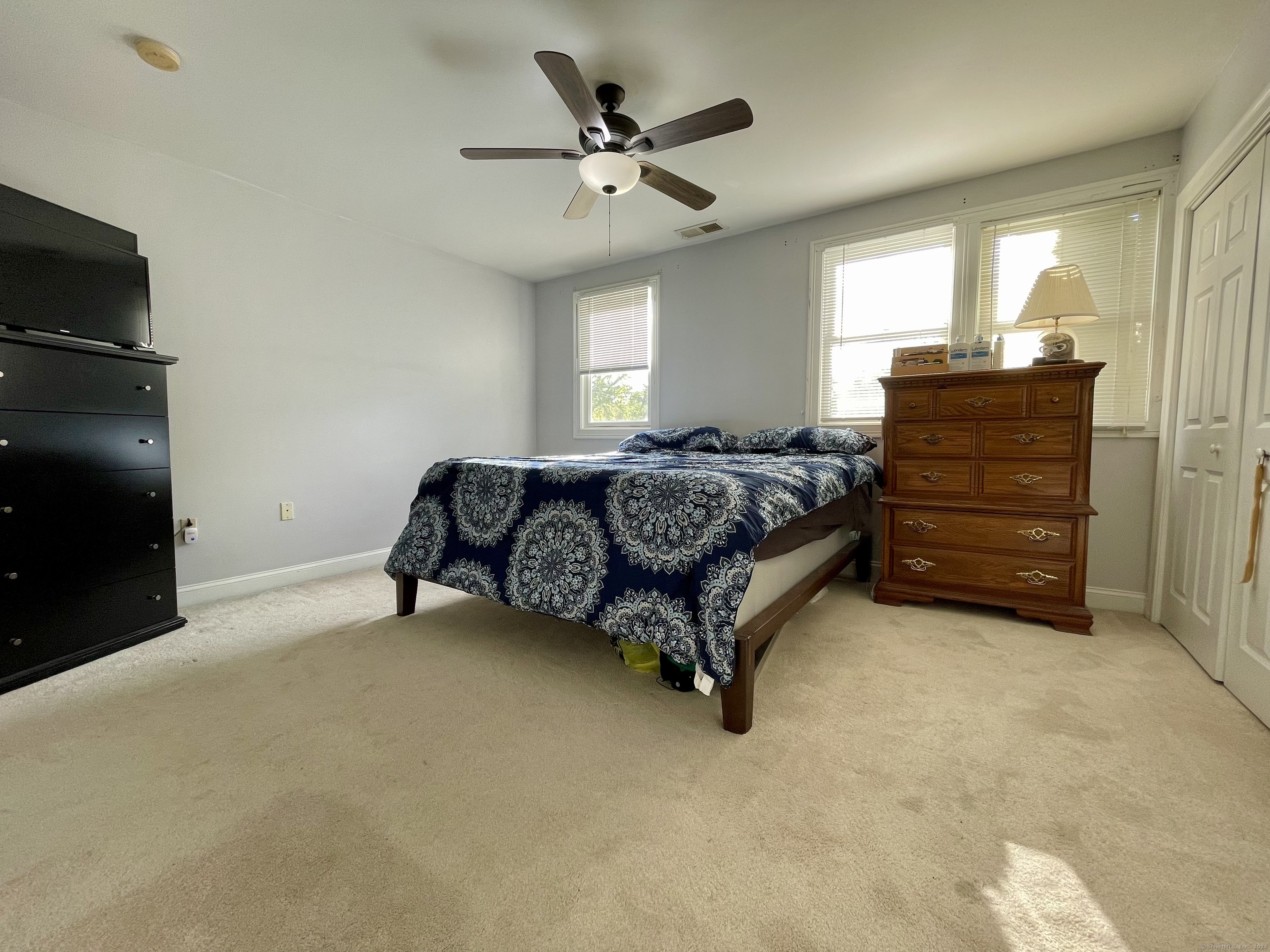 70 Grimes Road Rocky Hill, CT 06067 - Photo 11 of 23 a spacious bedroom with a bed and a ceiling fan