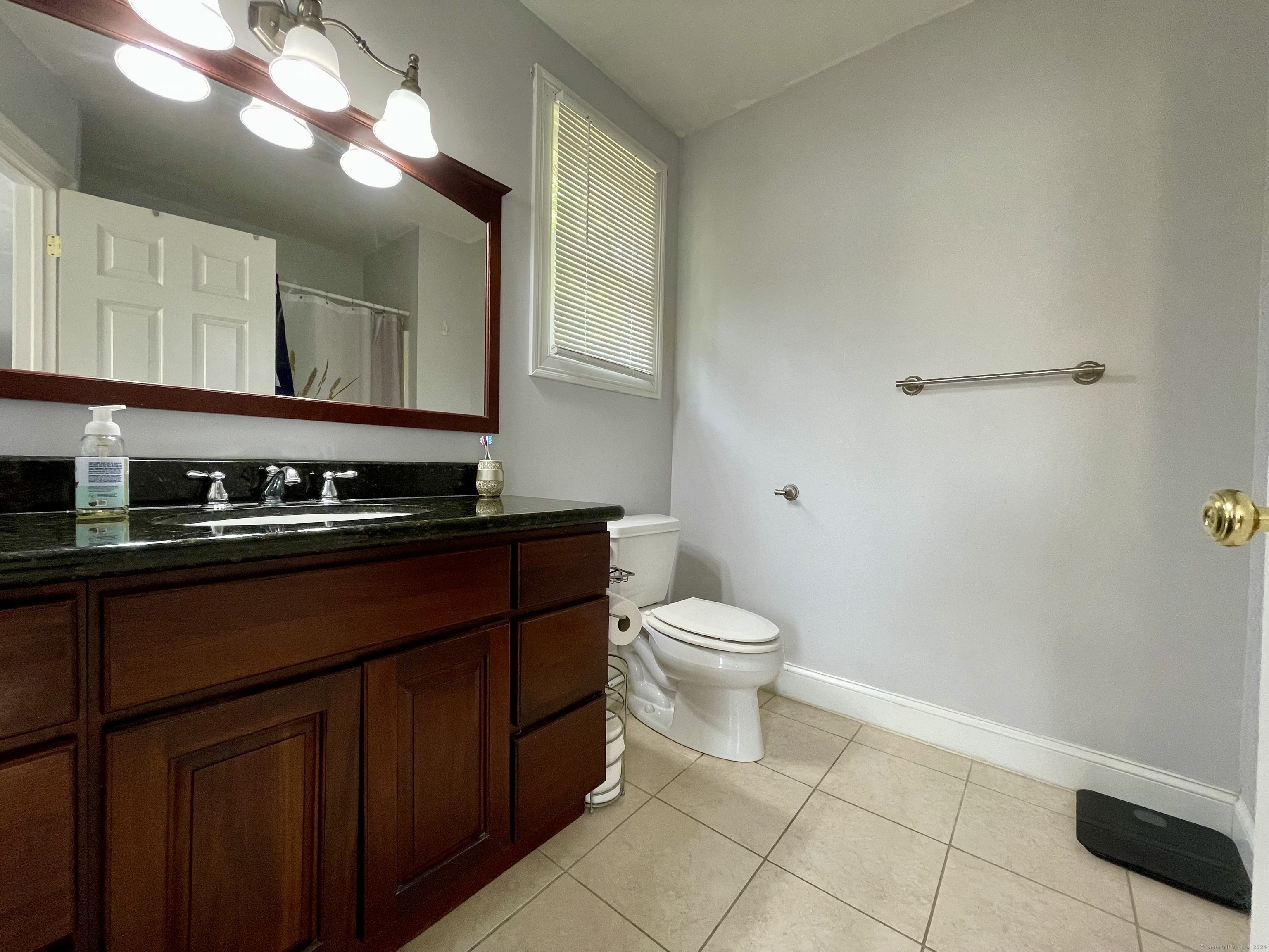 70 Grimes Road Rocky Hill, CT 06067 - Photo 12 of 23 a bathroom with a sink a toilet and a mirror
