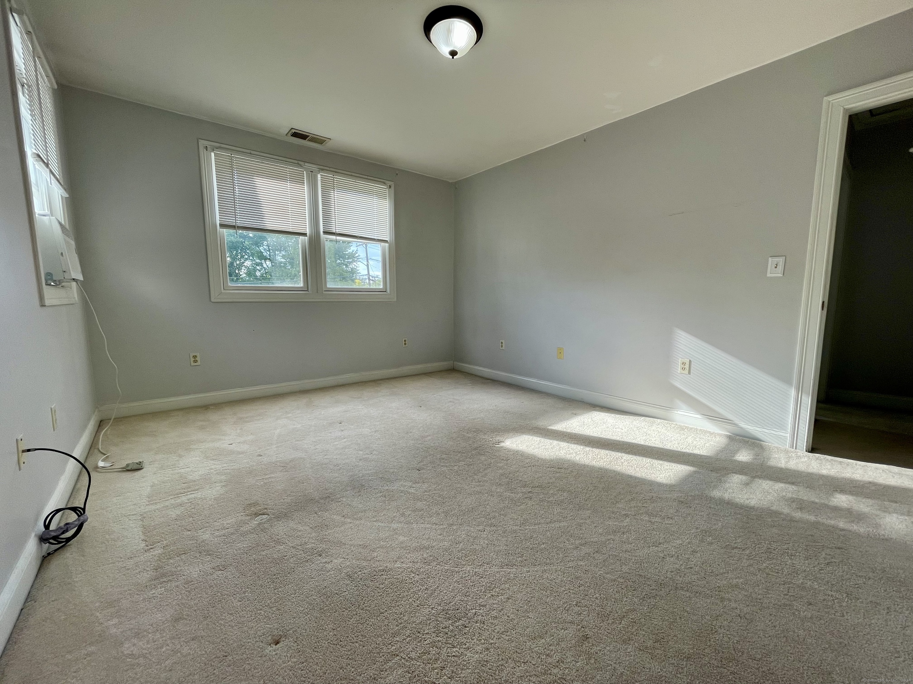 70 Grimes Road Rocky Hill, CT 06067 - Photo 18 of 23 an empty room with windows and entrance