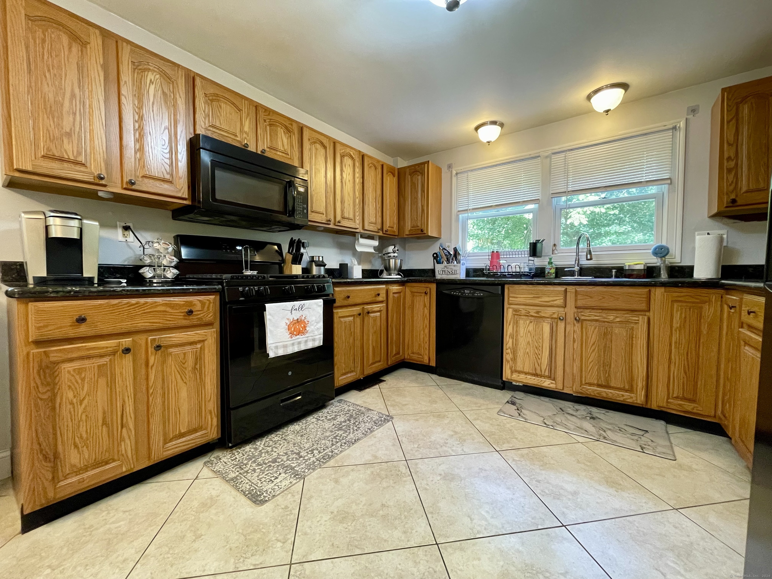 70 Grimes Road Rocky Hill, CT 06067 - Photo 2 of 23 a kitchen with stainless steel appliances granite countertop a stove top oven a sink dishwasher and cabinets with wooden floor