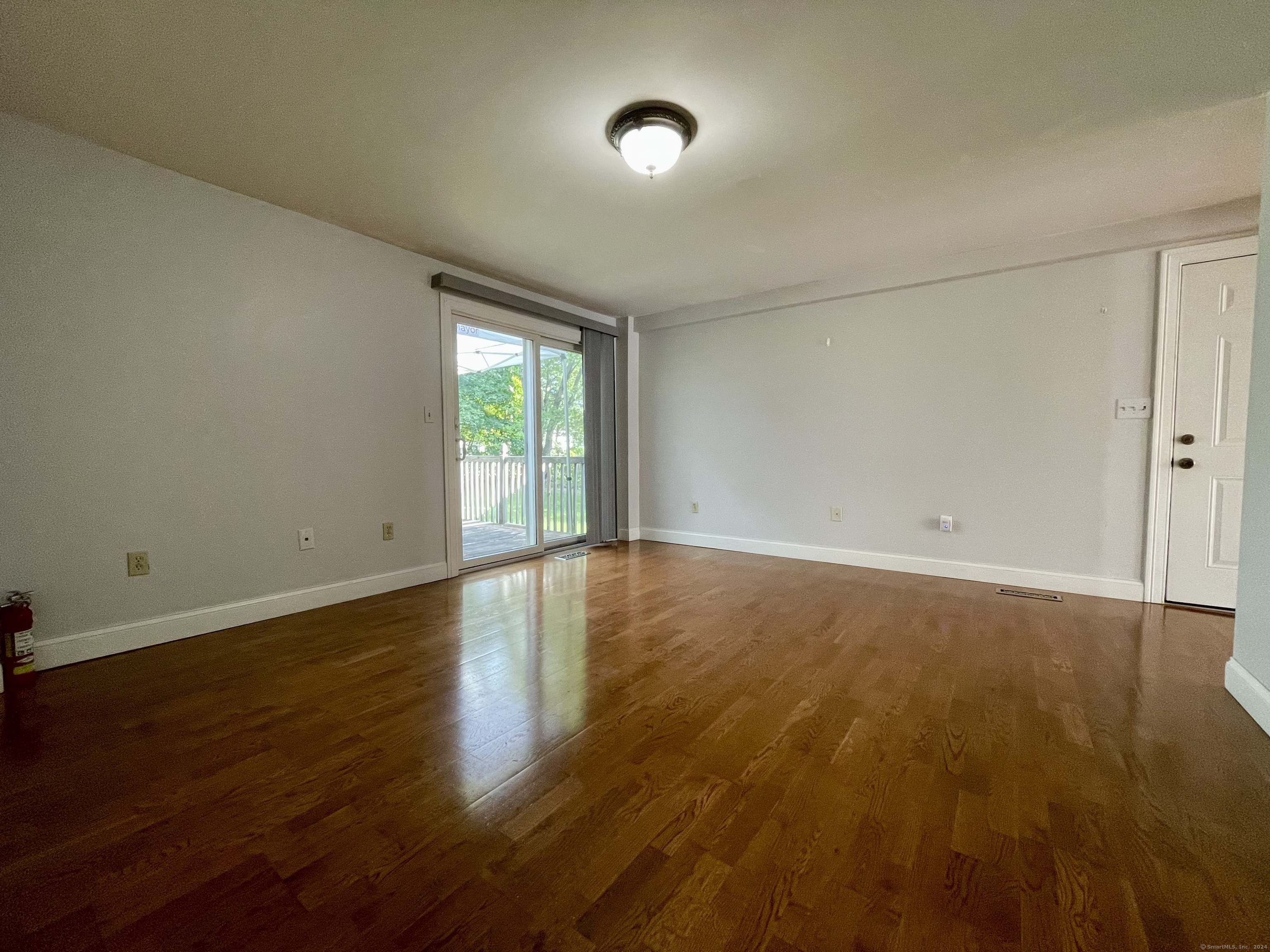 70 Grimes Road Rocky Hill, CT 06067 - Photo 8 of 23 a view of an empty room with wooden floor and a window