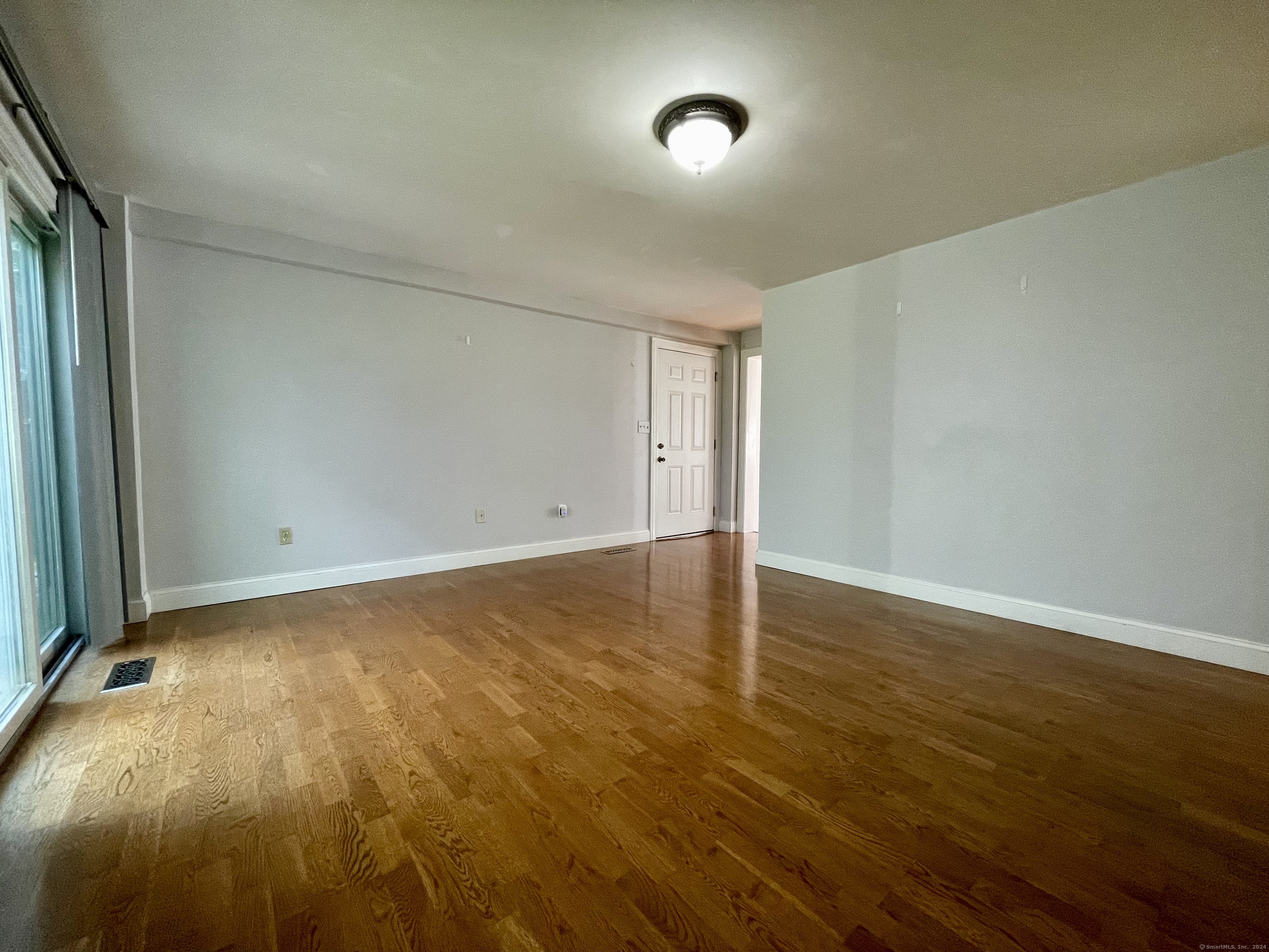 70 Grimes Road Rocky Hill, CT 06067 - Photo 10 of 23 an empty room with wooden floor and windows