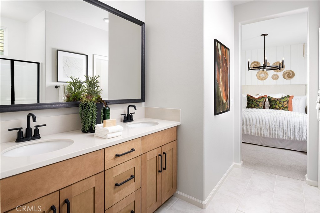 4083 Summer Way Corona, CA 92883 - Photo 12 of 18 a bathroom with a double vanity sink and mirror