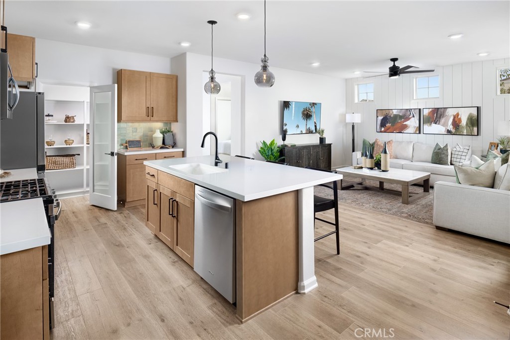 4083 Summer Way Corona, CA 92883 - Photo 6 of 18 a large kitchen with stainless steel appliances kitchen island granite countertop a large island in the center