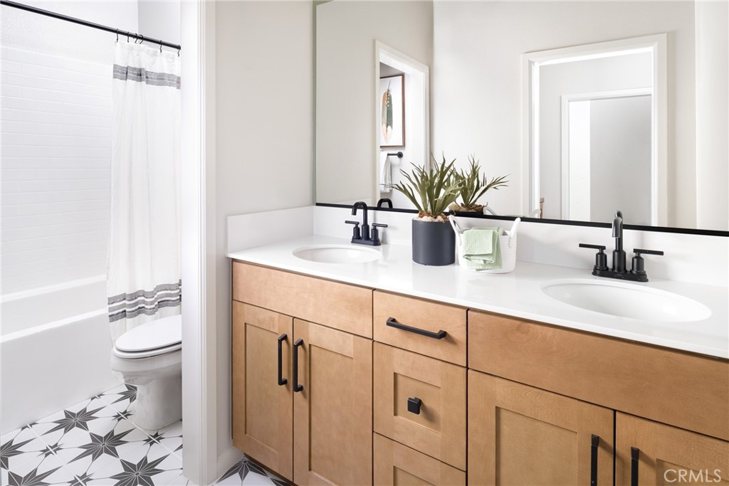 4083 Summer Way Corona, CA 92883 - Photo 10 of 18 a bathroom with a sink a toilet and a mirror