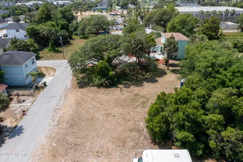 an aerial view of a house with a yard and lake view