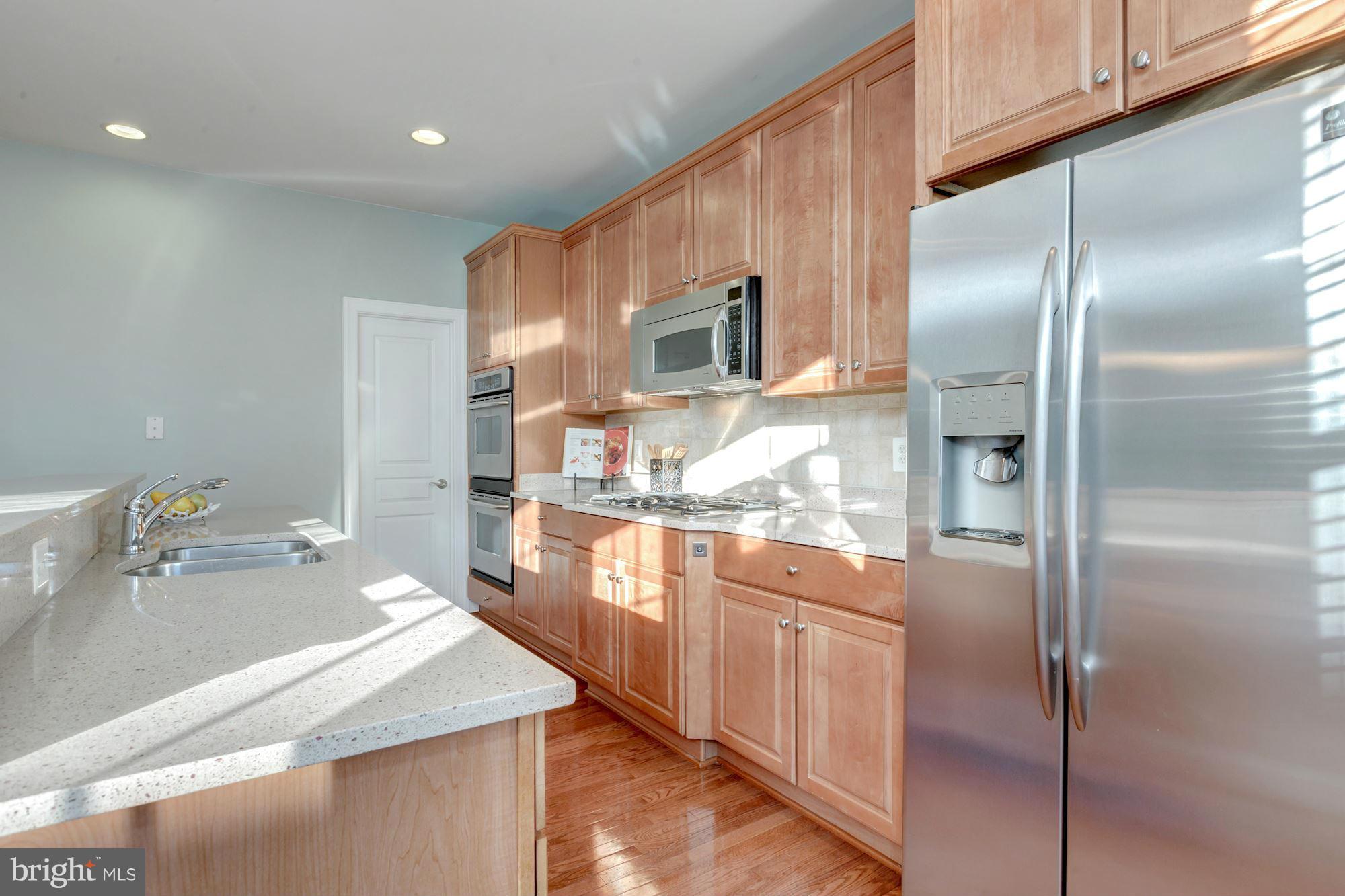 397 Spring Street Herndon, VA 20170 - Photo 11 of 30 a kitchen with stainless steel appliances granite countertop a refrigerator a sink and a stove